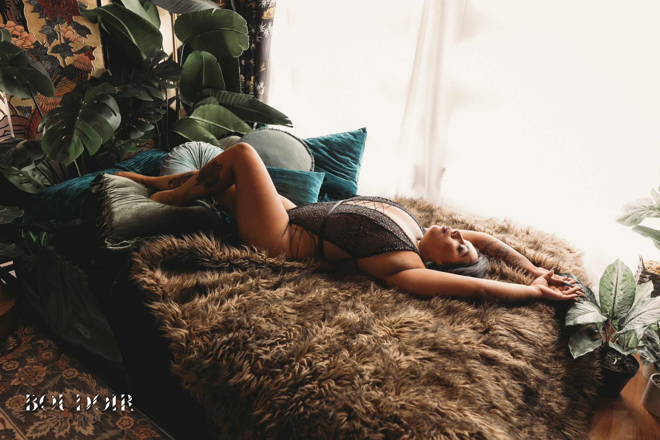 Woman with Tattoos in a Boudoir session Celebrating Beauty