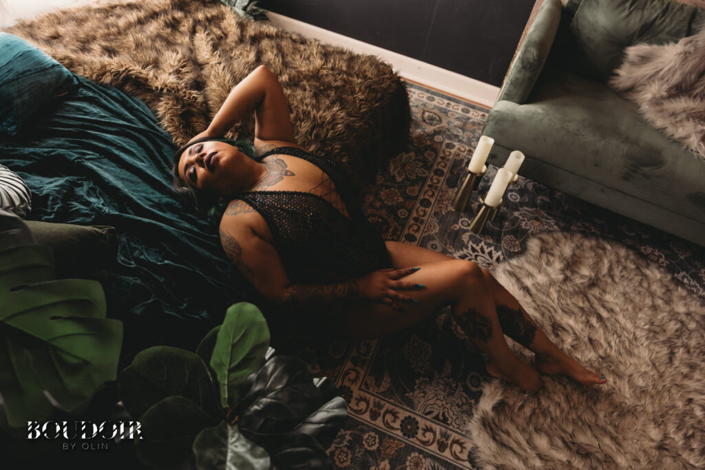 Woman with Tattoos doing Boudoir pose Celebrating Beauty