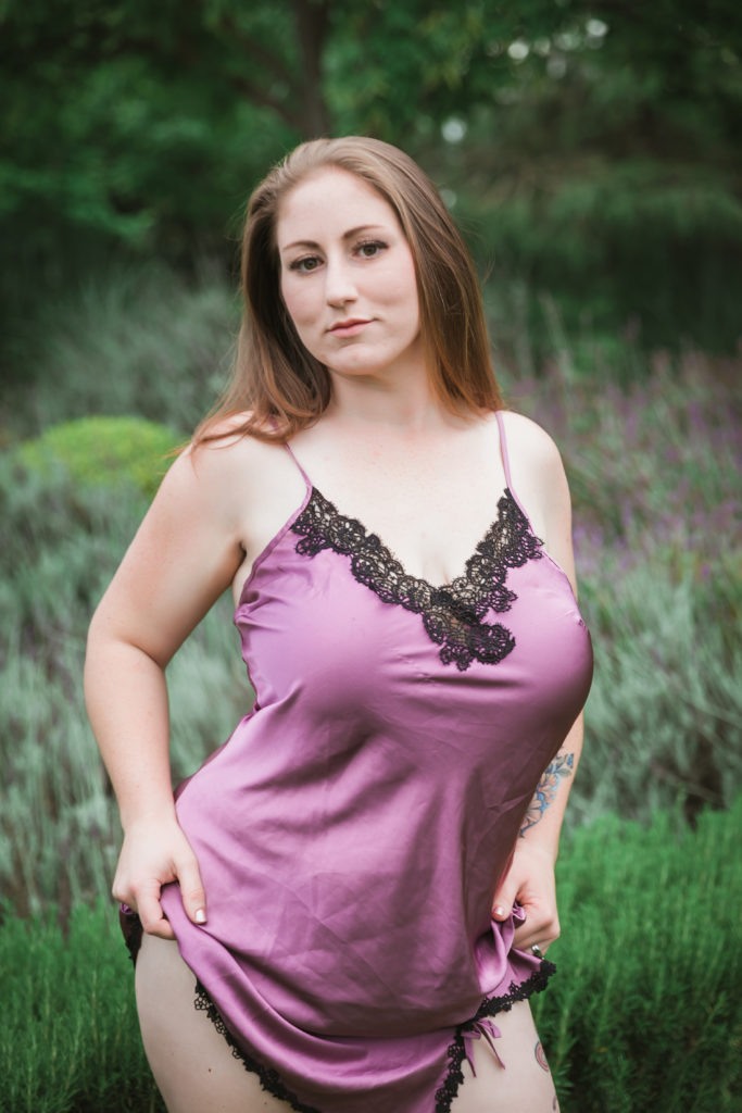 Woman in purple lingerie posing for boudoir photo shoot outdoors in northern California
